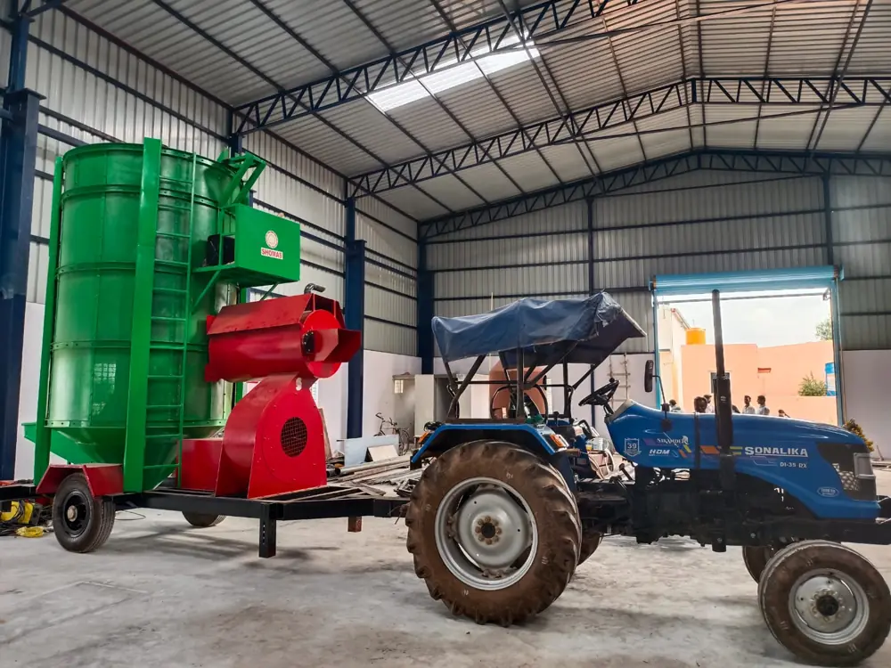 Shomas green tower grain dryer on a trailer hitched to a tractor