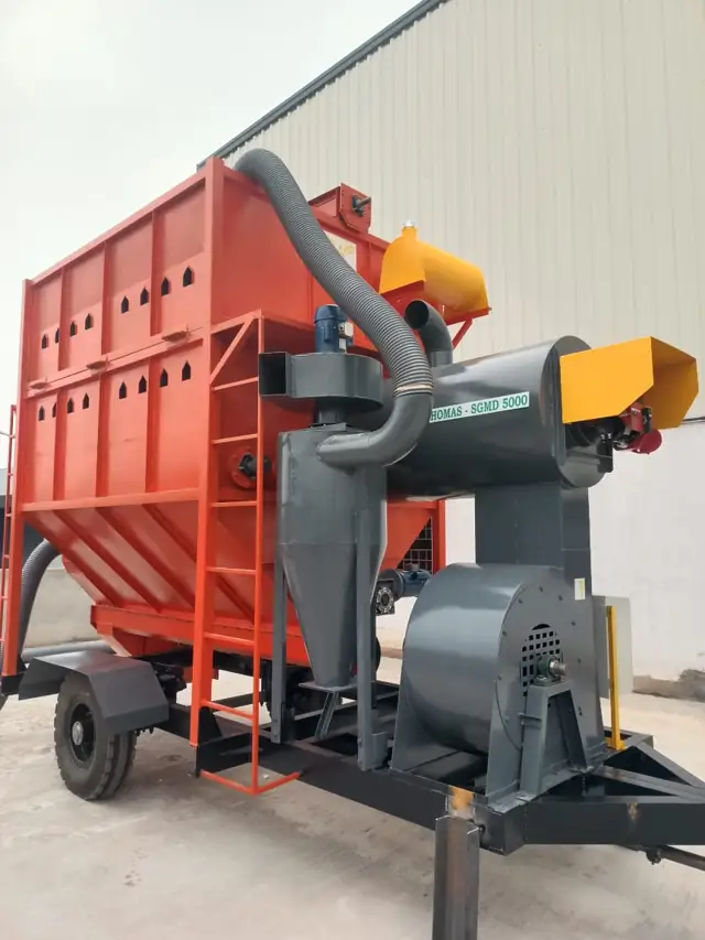 Side angle of Shomas mobile paddy dryer showing hopper, cyclone and blower