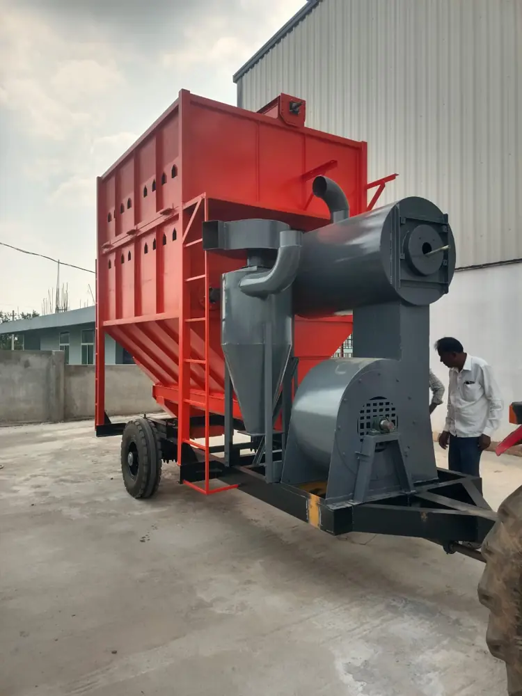 Side view of the orange Shomas mobile grain dryer hopper and cyclone