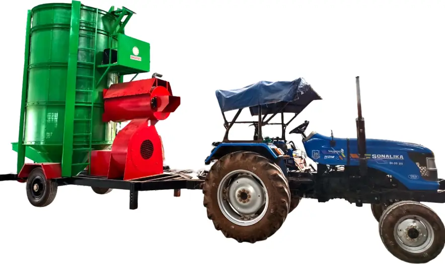 Tractor towing a mobile grain dryer between farm locations